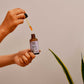 Rosehip seed oil dropper bottle in hands